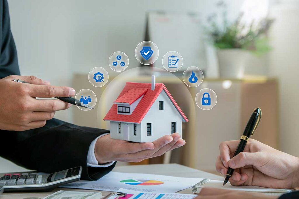 A person reviews insurance documents and a payment notice on a kitchen table with a cup of coffee nearby.